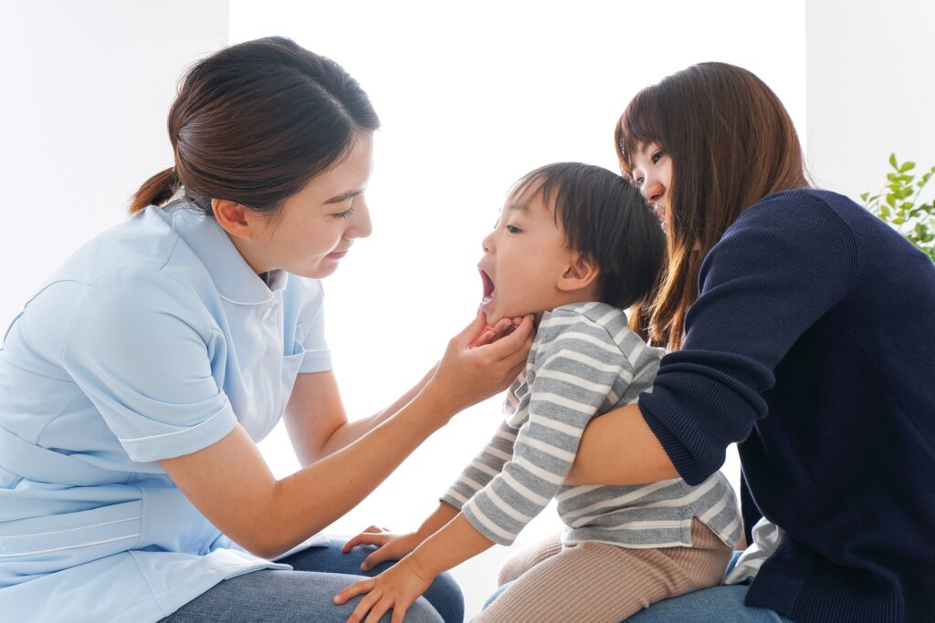 歯医者さんと子どもを抱っこしている母親